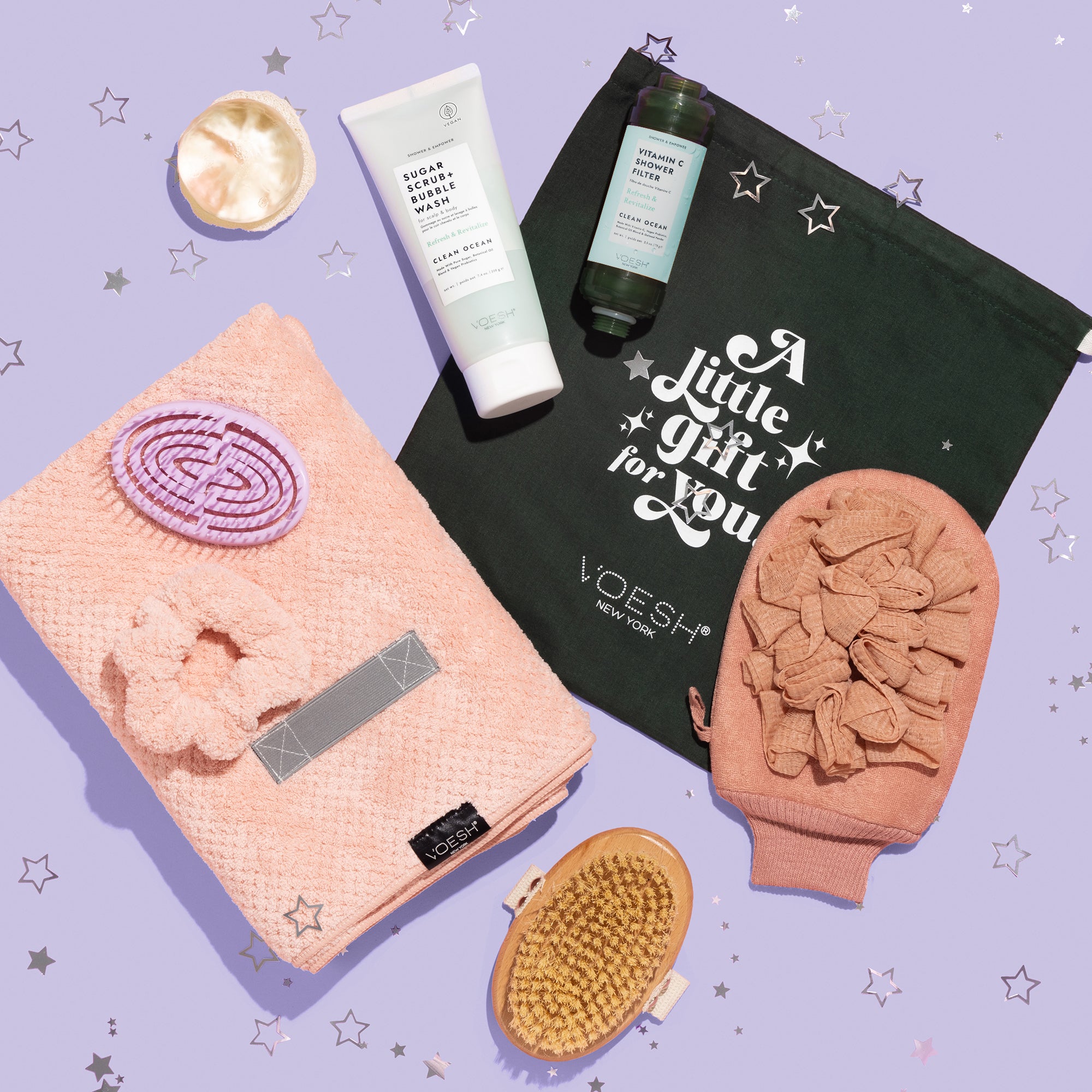 VOESH New York Holiday Pure Shower Bliss holiday kit, laid out on top of a purple starred background.